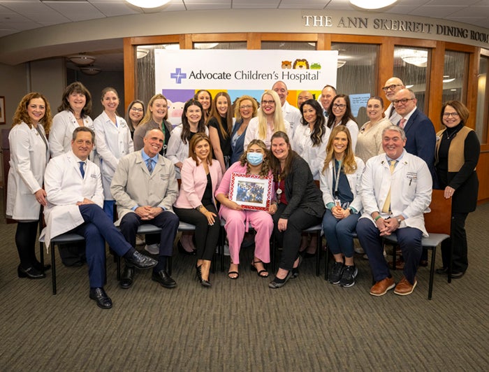 Advocate Children's transplant patient Nataly Paramo sits smiling in a group photo with the Advocate transplant team