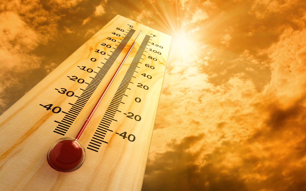 Preparing for Extreme Heat: 6 Best Practices for Hospitals. A thermometer with the temperature above 40 degrees Celsius and 100 degrees Fahrenheit rises into the sky where the sun is shining brightly.