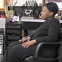 palliative care patient Debbie sitting in chair in her salon