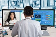 To Drive Your Telehealth Strategy, Answer One Simple Question image of clinician telecommunicating with patient on one computer screen and medical data on another.