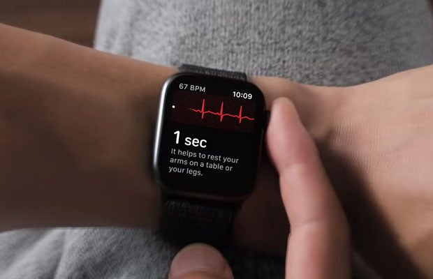 Could Emerging Sensors Revolutionize Wearable Technology? Person tapping on smartwatch with heart monitor visible on it.