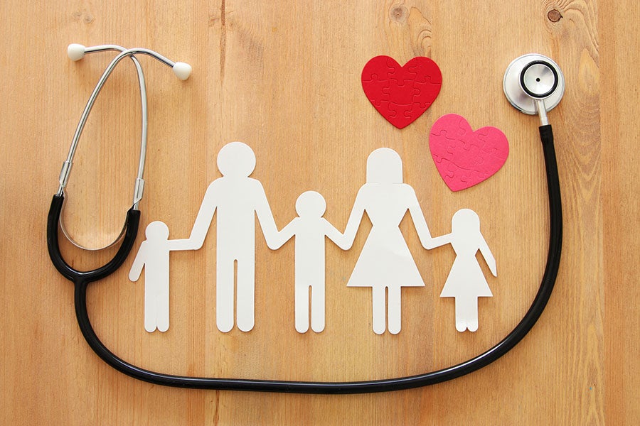 paper cutout of family surrounded by stethoscope