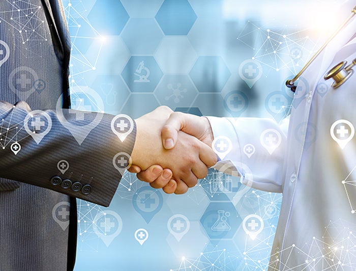 business man shaking hands with doctor