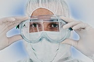 AHA Market Scan Pandemic Could Reshape Physician Practice Landscape, Pay Models. Photo of a physician with a mask, goggles, and gloves on.