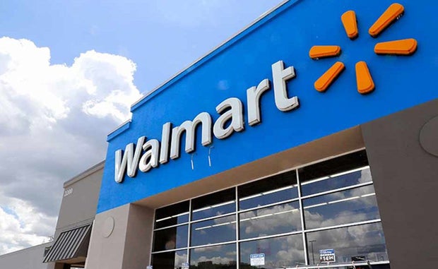 Walmart Enters New Phase of Its Health Care Relationship with Consumers. The front of a Walmart store showing the Walmart name above the entry doors.