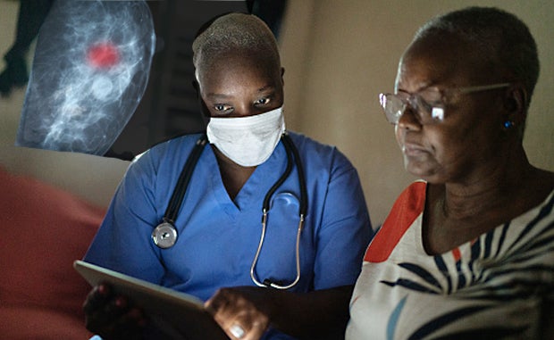 Data-Driven Initiative Drives Down Disparities in Rural Health Care. A Black clinician and a Black patient review a mammogram taken of the patient.