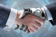Innovation Collaborative Targets Robotic Process Automation. A human hand in emerging from a shirt cuff and suit jacket shakes hands with a robot hand emerging from a shirt cuff and suit sleeve.