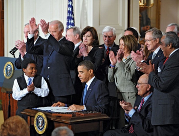 President Obama siging the Affordable Care Act