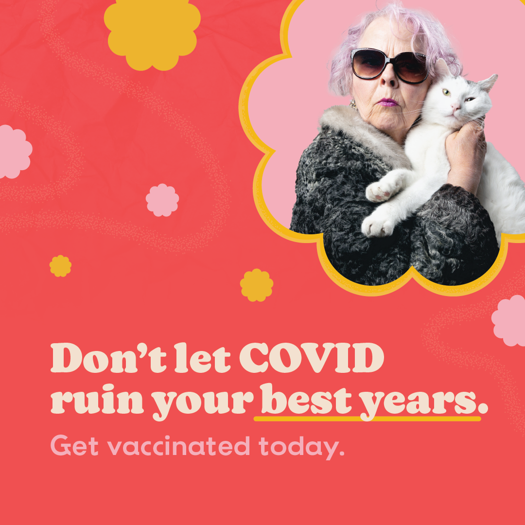 Elderly white woman in rockstar sunglasses, pink tinted hair and fur coat clutches a cat to her chest. Text: Don't let COVID ruin your best years. Get vaccinated today.