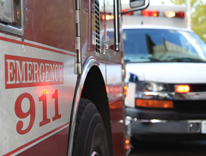 Stock photo of ambulance and emergency vehicle with 'Emergency 911' written on door