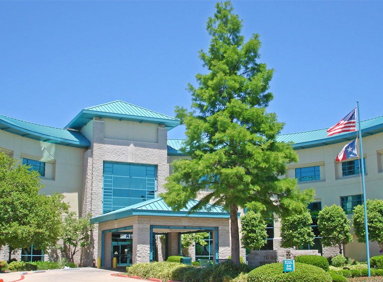 Titus Regional Medical Center exterior shot of tan brick building with green trim
