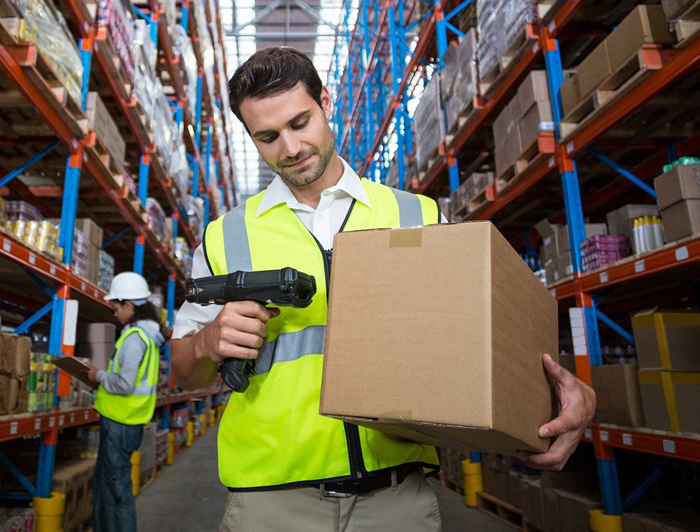 Person scanning a package in a warehouse