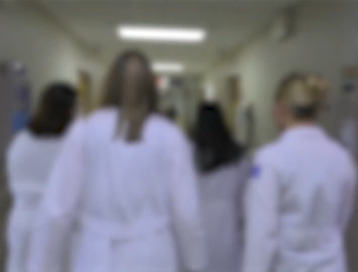 Garrett Regional Medical Center, Jefferson Health, George Washington University Hospital. Video still features blurred image of backs of 4 female clinicians in white coats as they walk down a hospital hallway