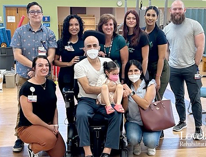 Lovelace UNM Rehabilitation Hospital. Cesar and Lily Colmenero and family with Lovelace staff
