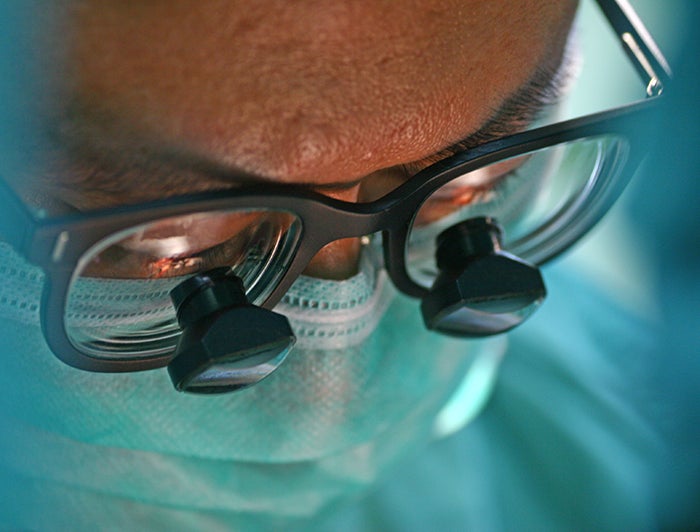 MUSC Health Shawn Jenkins Children's Hospital. Stock image of a surgeon in theater wearing surgical magnifying glasses