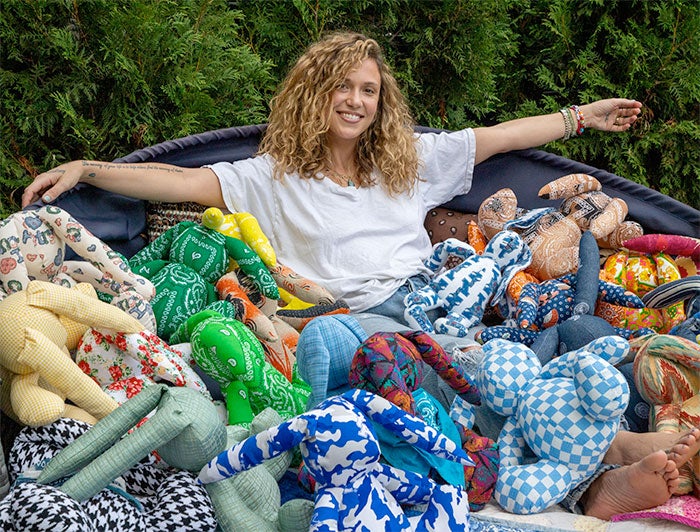 UK Healthcare - Caroline Bentley Noble sits amid a pile of her bunnies