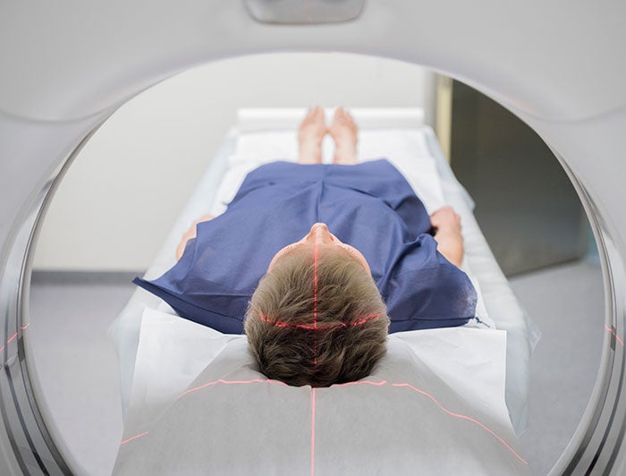 Mass General. Stock image of a patient entering a proton therapy or MRI device