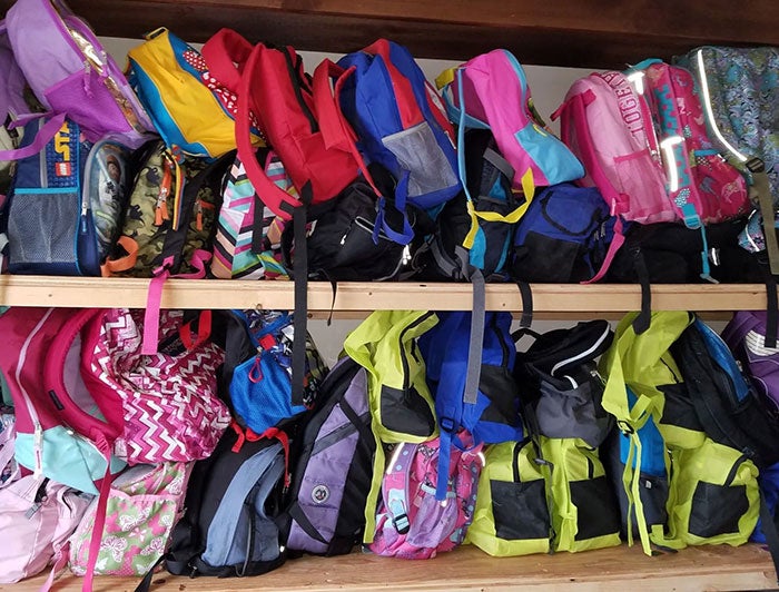 Northeastern Vermont Regional Hospital. Stock image of rows of filled youth backpacks