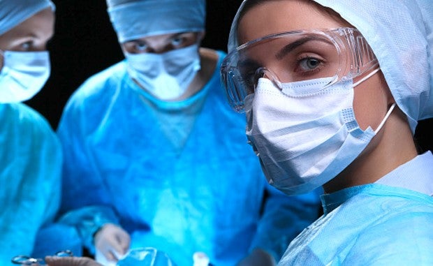 4 Health Care Workforce Moves to Make Now. Surgeons look at the camera during an operation.