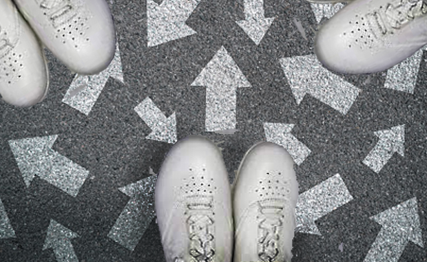 Innovative Nurse Residency Program Aims to Reduce Nurse Turnover. White nursing shoes on a floor covered in white arrows pointing in all directions.