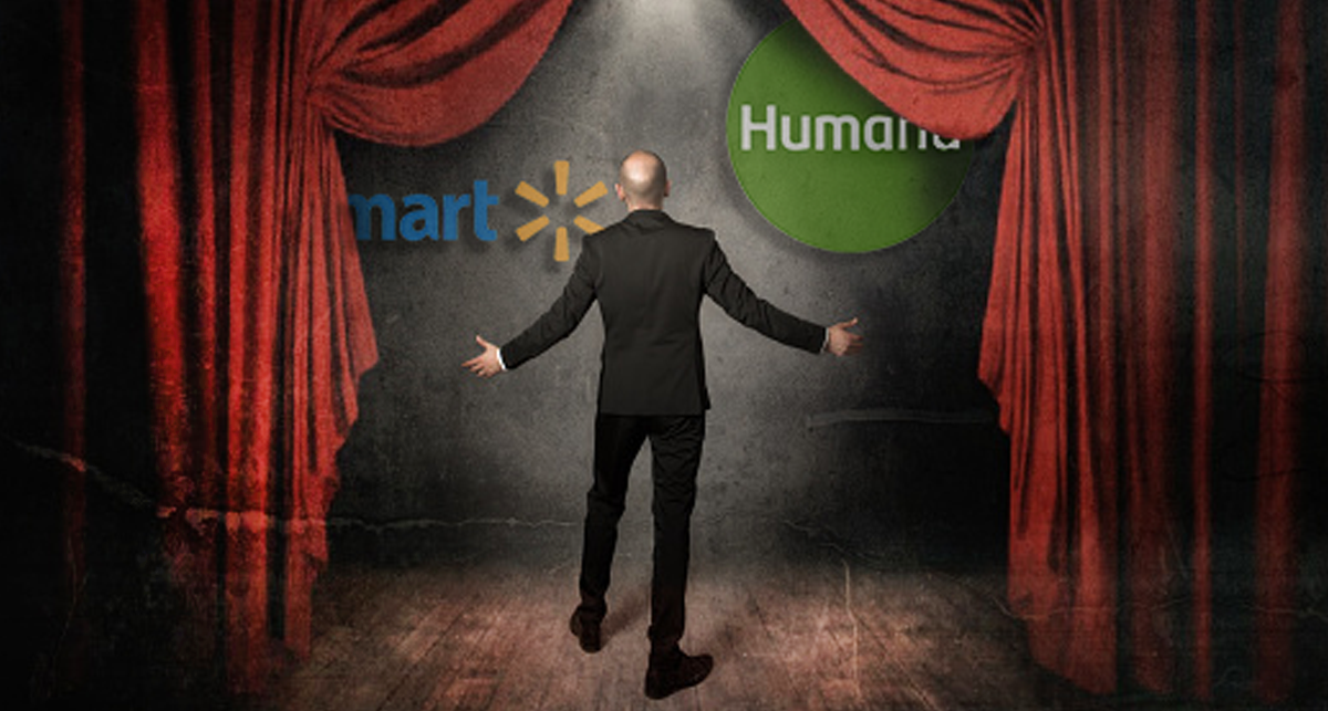 What’s Behind the Humana-Walmart Lease Deal to Provide Primary Care to Seniors? A performer on a stage opens a curtain to reveal the Walmart and Humana logos.