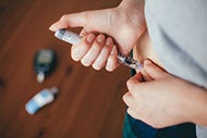 CVS Health Upends the Diabetes Drug Market. A diabetic individual self-administering a dose of insulin to belly using a syringe.