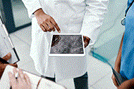 Image of a doctor showing other clinicians an ultrasound on a tablet