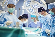 AHA Market Scan 3 Considerations for Restarting Surgical Service During the Pandemic. Surgeons and other clinical staff in an operating theater.