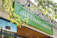 Oak Street’s RubiconMD Acquisition to Drive Virtual Specialty Care. Oak Street Health sign on the front of a building.