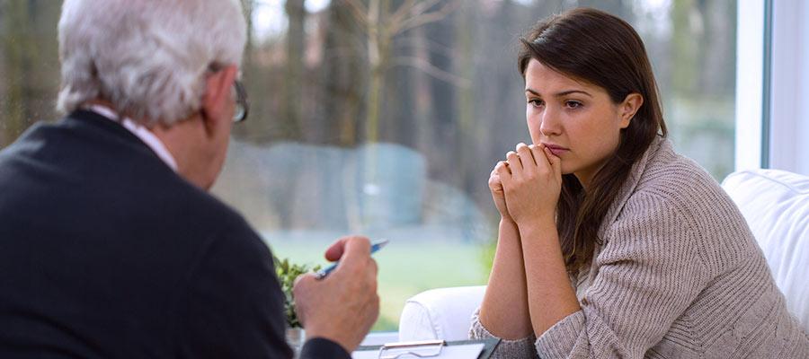 concerned woman speaking with counsellor