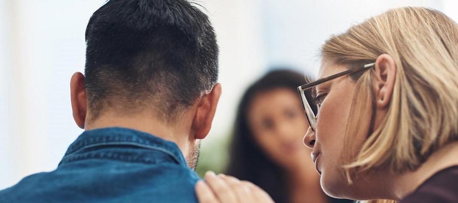 People Matter, Words Matter poster on supportive language for discussing PTSD. A woman comforts a man in a group setting.