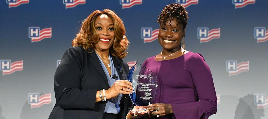 Two-women-hold-AHA-Equity-of-Care-Award-and-smile