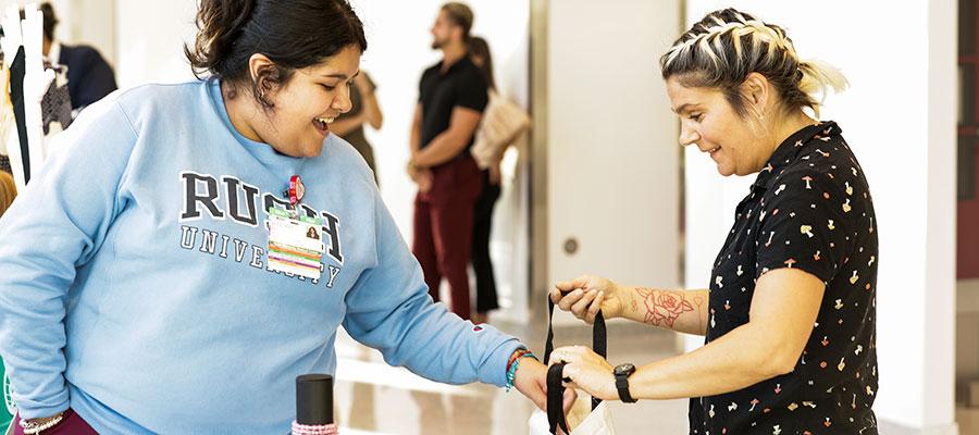 Innovations in Improving Community Health: The CHW Hub at RUSH. A clinician shares a gift bag with a community member.