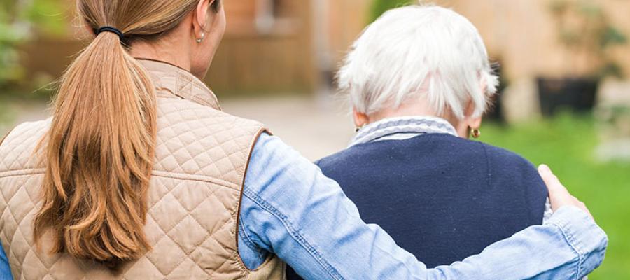 stock-elderly-woman-escorted-by-younger-from-behind_900x400.jpg