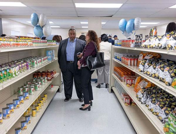 People stand in the aisles of the grocery store