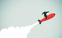 Redesign Health Gets Another Boost in Funding Startups to Innovate Care. A business man in a suit rides a rocket spewing exhaust thrust into the sky.